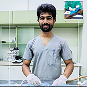 DR Jawad Ahmed standing in a happy mood before a cat surgery. The Image is especially taken for Vet Directory