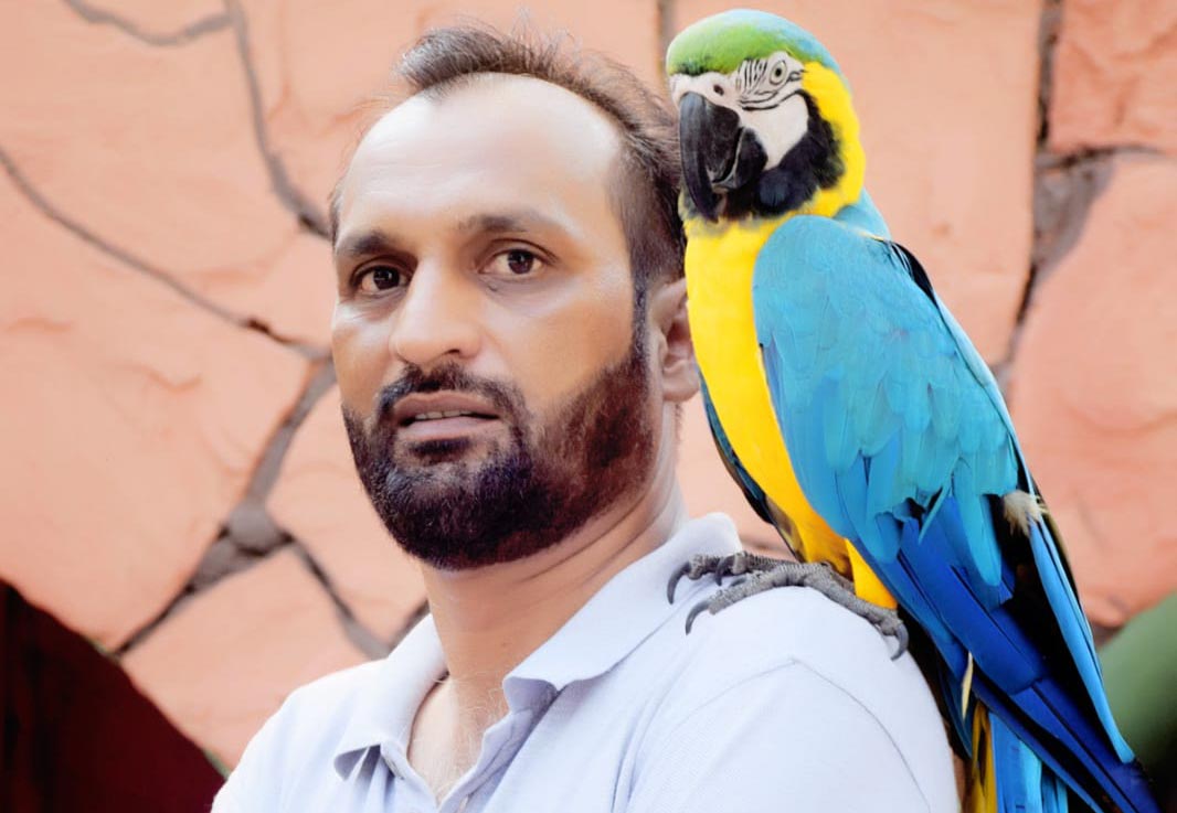 Jehanzaib Ahmed with his Pet Macaw in the shoulder