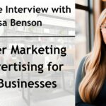 A professional promotional graphic for an exclusive interview with Lisa Benson on mastering marketing and advertising for a pet business. The image is divided into two sections. On the left, there is a blurred background of a modern office space with bookshelves, desks, and office decor. Over this background, bold black text reads: "Exclusive Interview with Lisa Benson" and "Master Marketing & Advertising for Pet Businesses," separated by a thin black horizontal line. On the right, a high-quality portrait of Lisa Benson, a woman with long blonde hair, wearing a black turtleneck and stylish tortoiseshell glasses. She has a confident expression and is in a warmly lit indoor setting with blurred background lights.