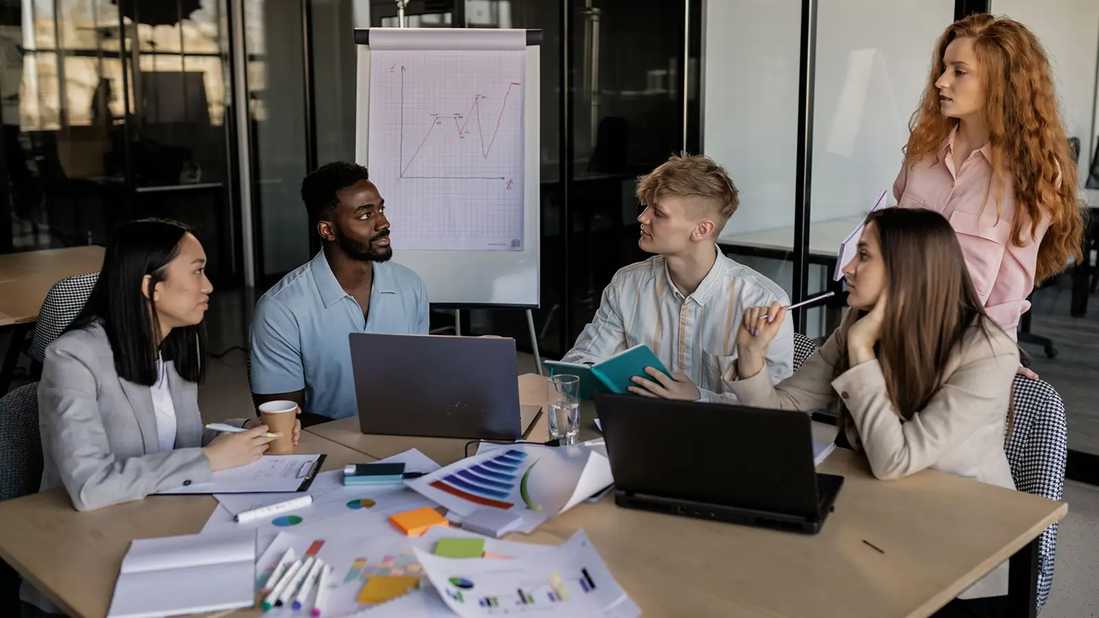 Business professionals collaborating around a table during a strategy and planning meeting about how to market a pet business.