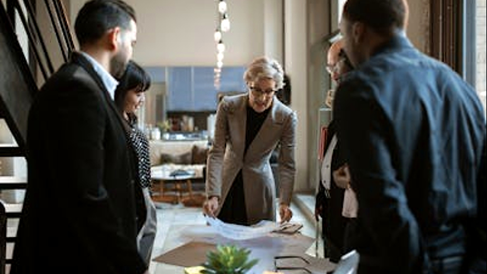 Business professionals collaborating around a table during a strategy and planning meeting.